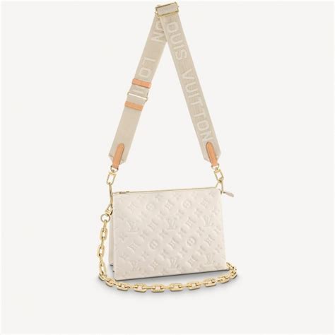 cream colored Louis Vuitton bag